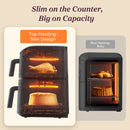 Cosori Turbo Tower diagram comparing heaters above each stacked basket with a rear-heating air fryer.